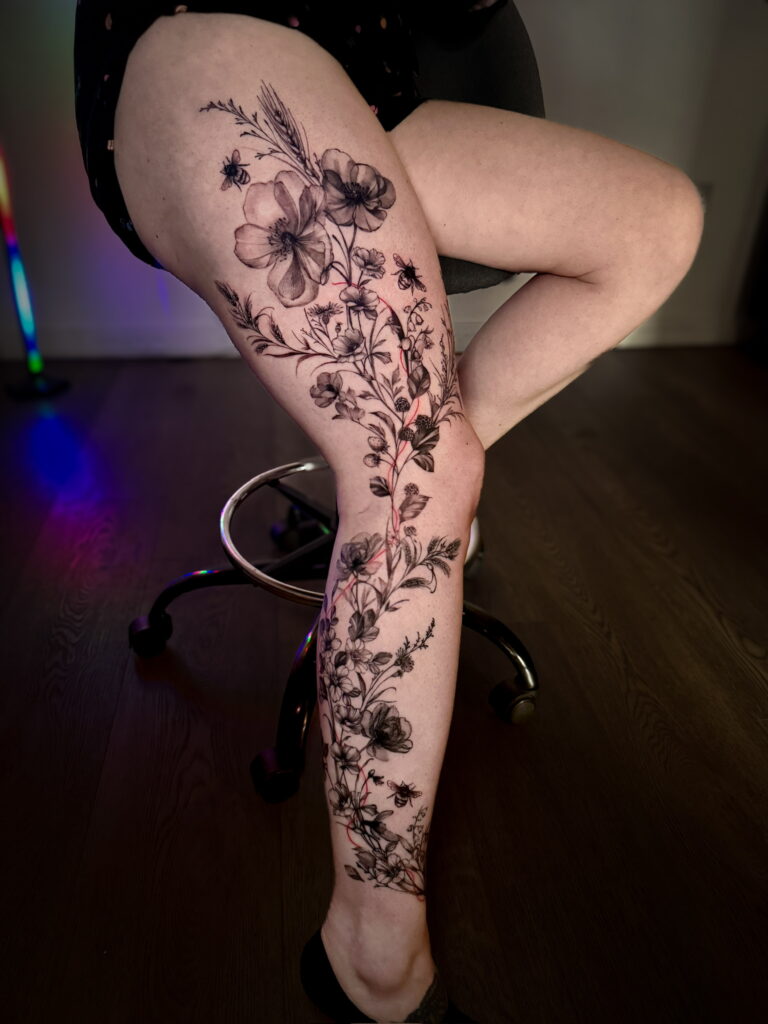 Detailed black ink botanical tattoo by Lena
