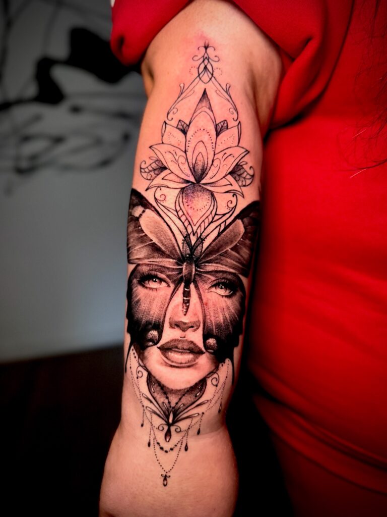 Surreal portrait tattoo with a moth and ornamental linework by Lena